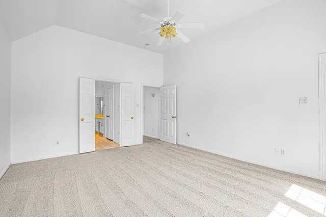 a view of a hallway with a ceiling fan