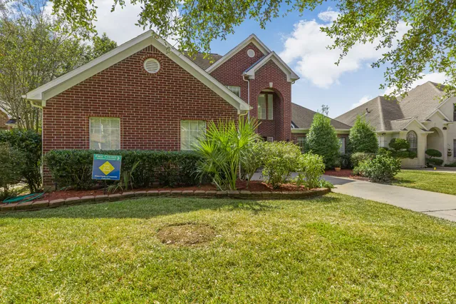 a view of a house with a yard and plants