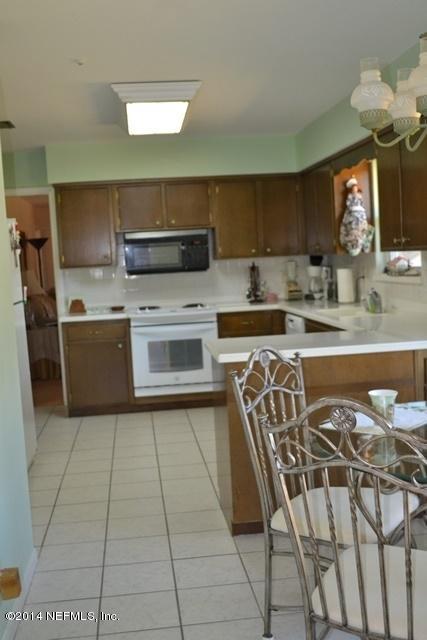 3943 Heath Road Jacksonville, FL 32277 - Photo 16 of 49 a kitchen with stainless steel appliances granite countertop a sink and a stove