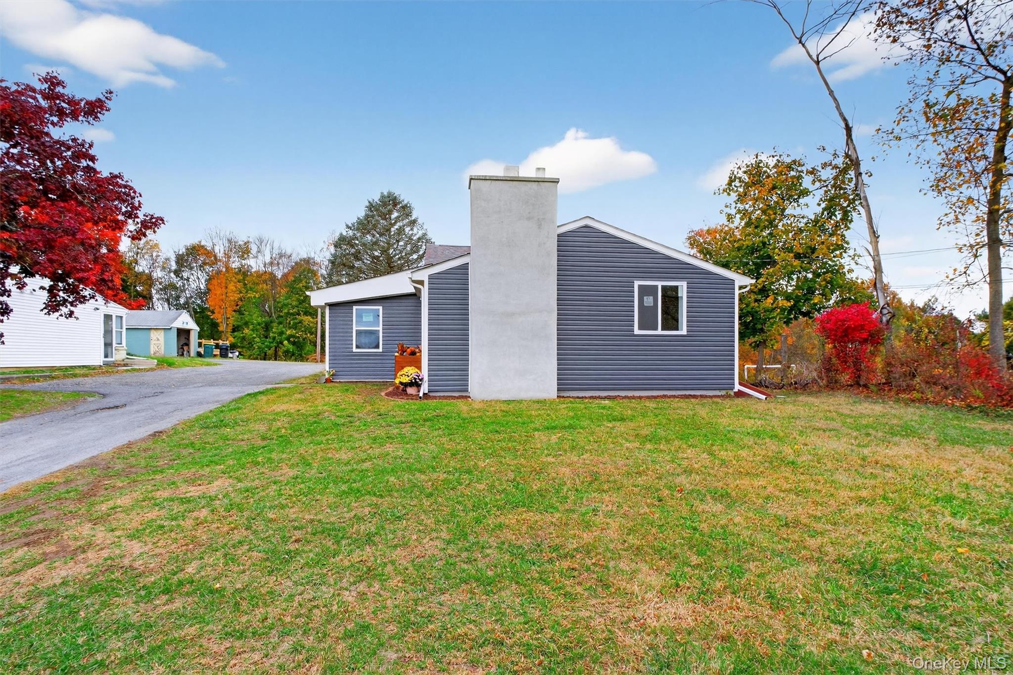 86 Vassar Road Poughkeepsie, NY 12603 - Photo 29 of 31 View of property exterior featuring a lawn and a chimney