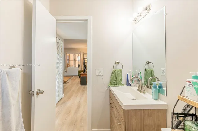 a bathroom with a sink vanity and a mirror