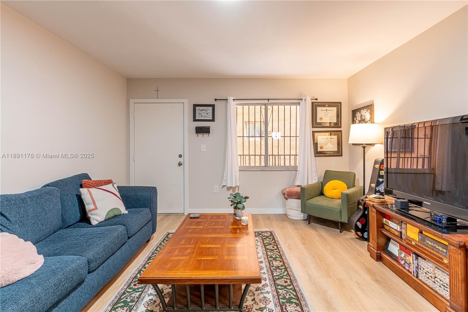 2921 Southwest 10th Street, Unit 26 Miami, FL 33135 - Photo 3 of 19 a living room with furniture and a flat screen tv