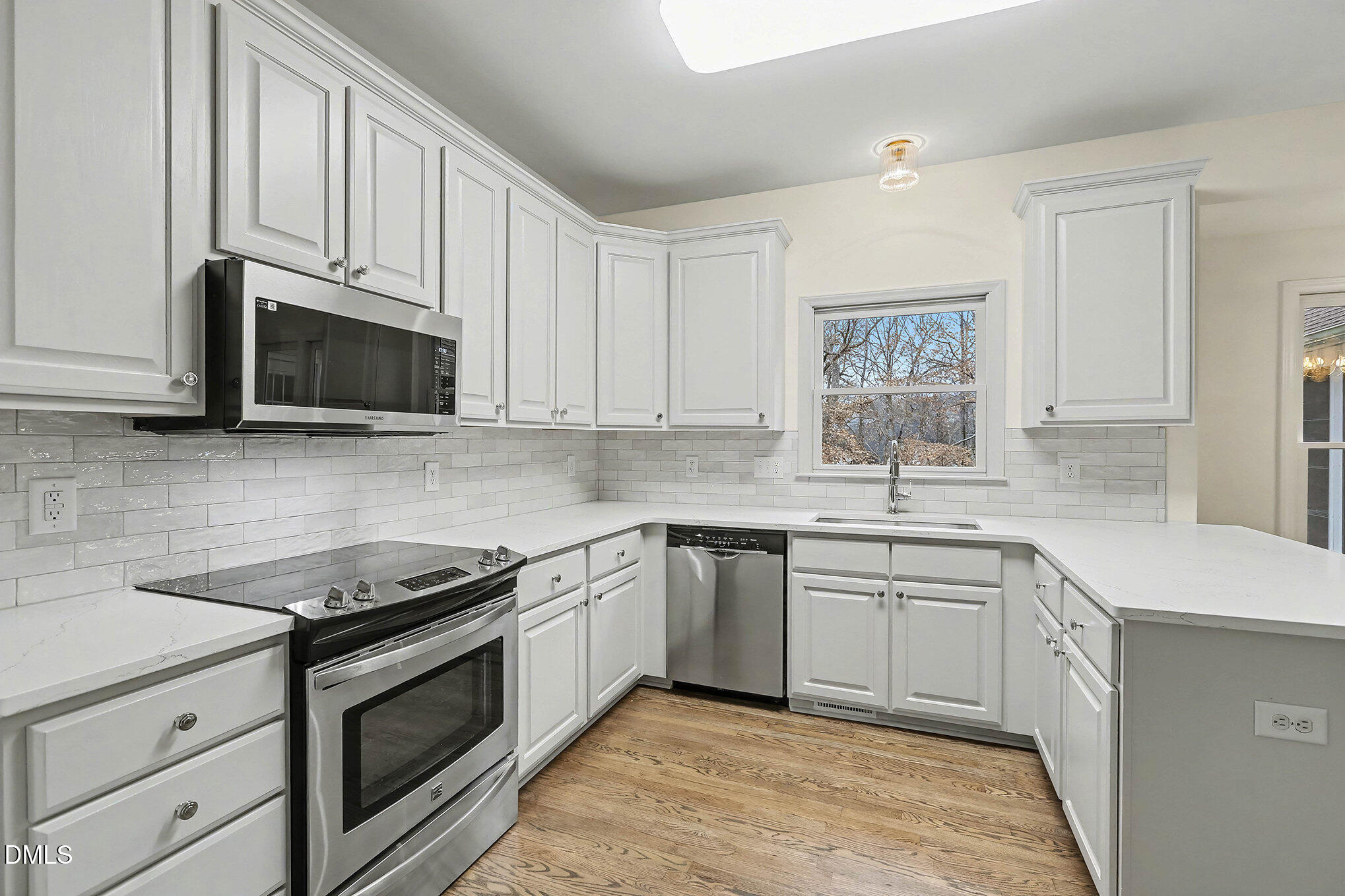 10415 Ashmead Lane Raleigh, NC 27614 - Photo 15 of 44 a kitchen with stainless steel appliances granite countertop a sink stove and microwave