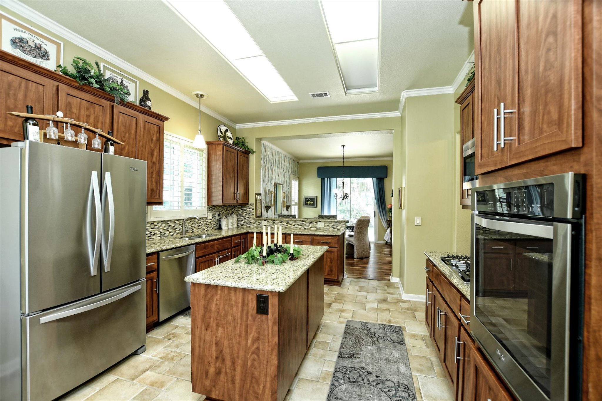 106 Nighthawk Way Georgetown, TX 78633 - Photo 11 of 29 Bright culinary space featuring wood cabinetry, stainless appliances, and granite countertops.