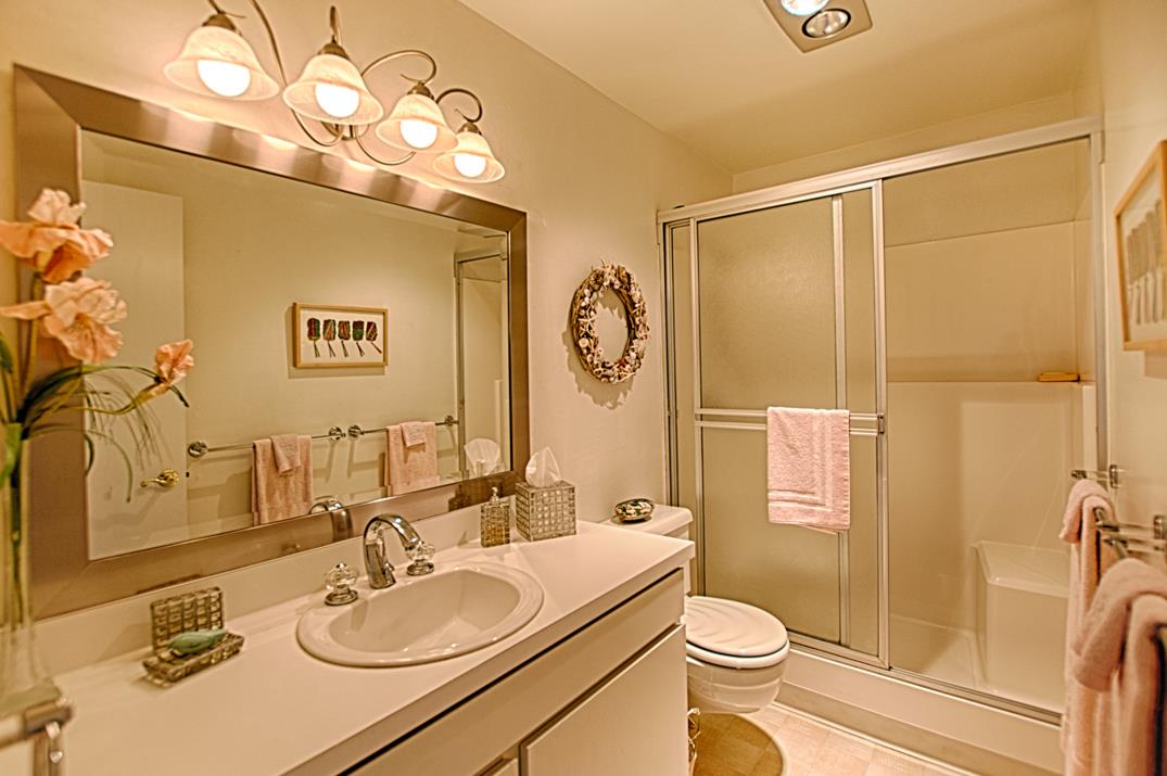 101 Shell Road, Unit 210 Watsonville, CA 95076 - Photo 11 of 26 a bathroom with a granite countertop sink mirror vanity and toilet