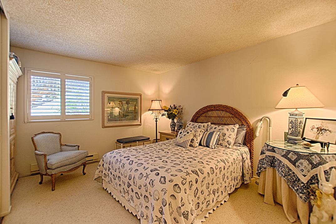 101 Shell Road, Unit 210 Watsonville, CA 95076 - Photo 12 of 26 a bedroom with a bed and chair