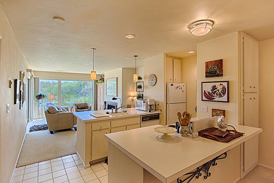 101 Shell Road, Unit 210 Watsonville, CA 95076 - Photo 8 of 26 a room with stainless steel appliances a stove a sink and a refrigerator