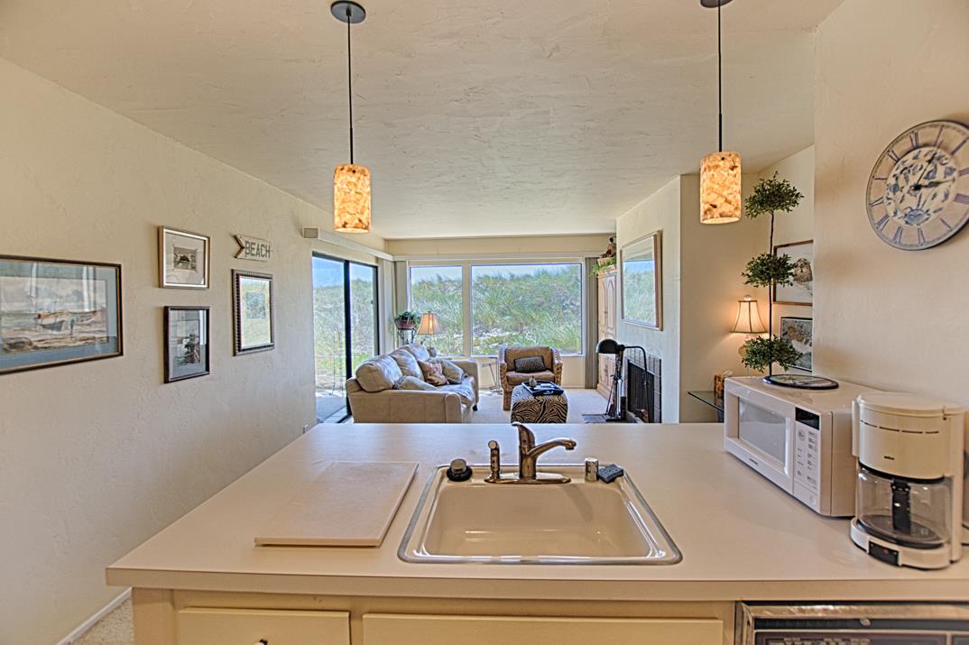 101 Shell Road, Unit 210 Watsonville, CA 95076 - Photo 9 of 26 a room with gym equipment and a chandelier