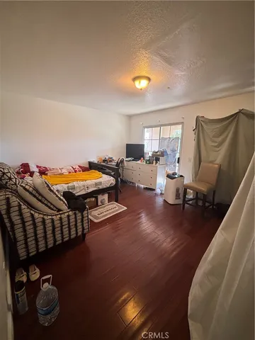 a bedroom with furniture and a wooden floor