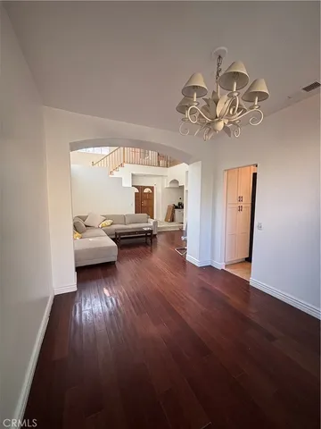 a view of a livingroom with furniture and chandelier fan