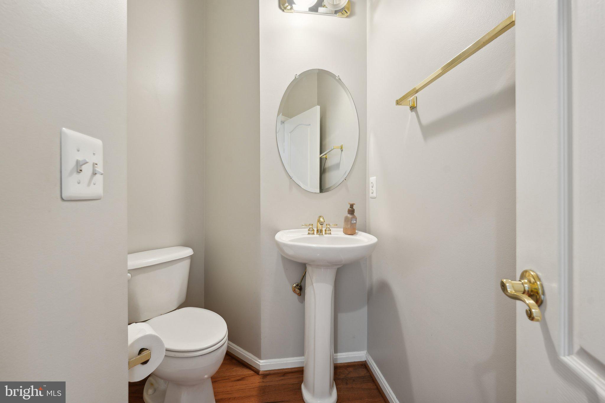 6244 Rolling Spring Court Springfield, VA 22152 - Photo 15 of 50 a bathroom with a sink toilet and a mirror