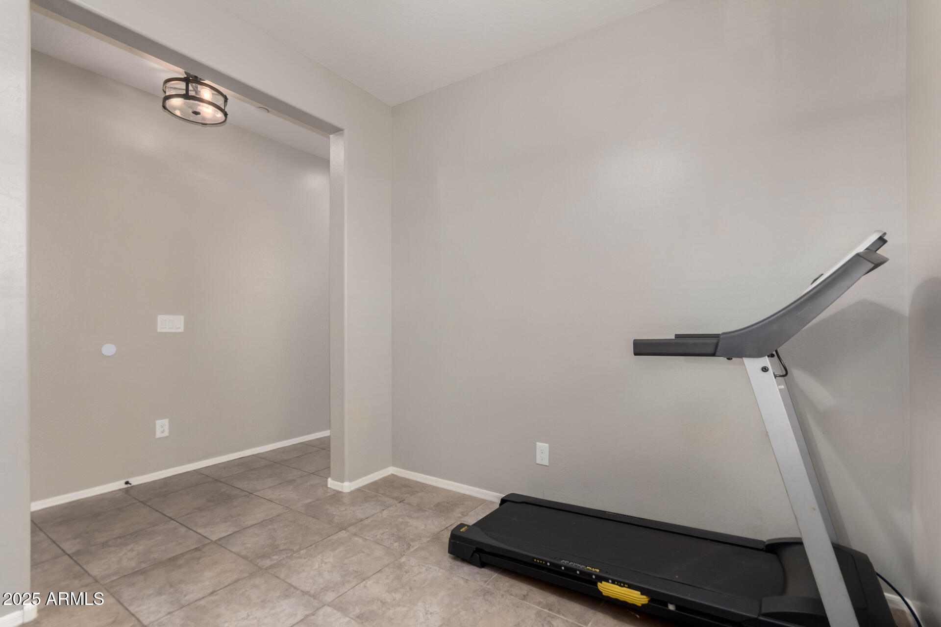 21243 West Coronado Road Buckeye, AZ 85396 - Photo 8 of 49 a room with a white cabinet and a wooden floor