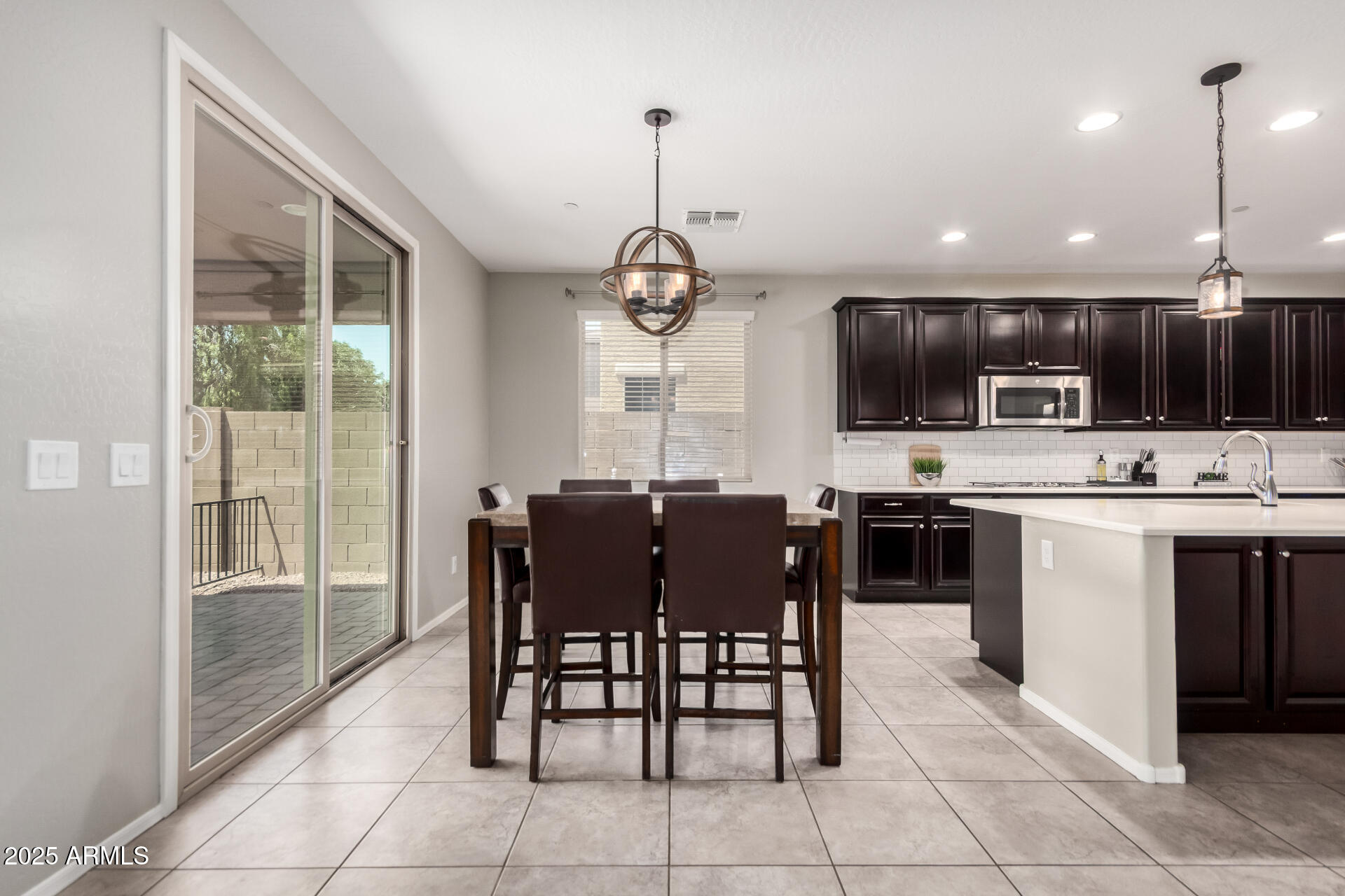 21243 West Coronado Road Buckeye, AZ 85396 - Photo 13 of 49 a view of kitchen with sink dining table and chairs