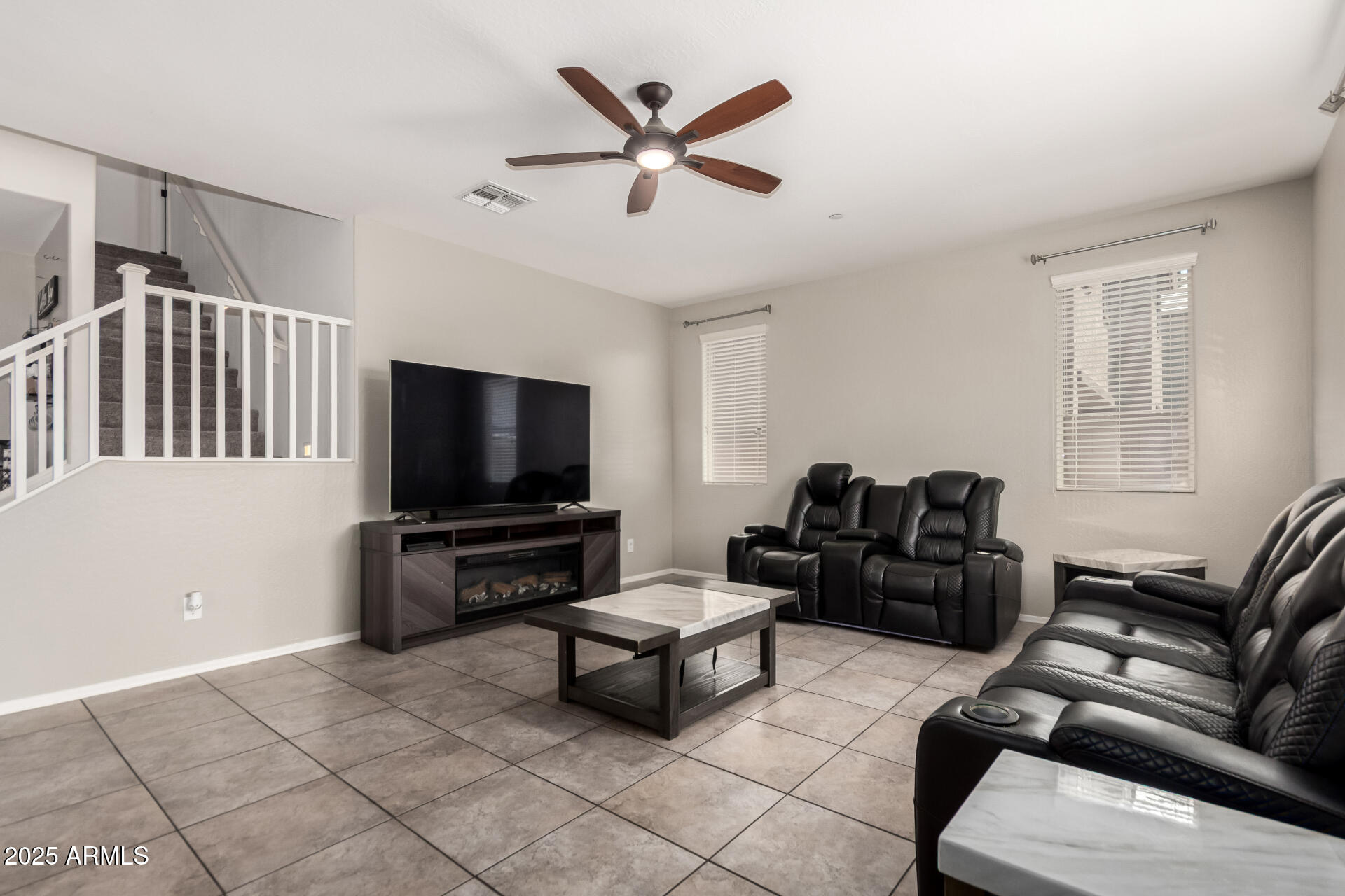 21243 West Coronado Road Buckeye, AZ 85396 - Photo 15 of 49 a living room with furniture and a flat screen tv