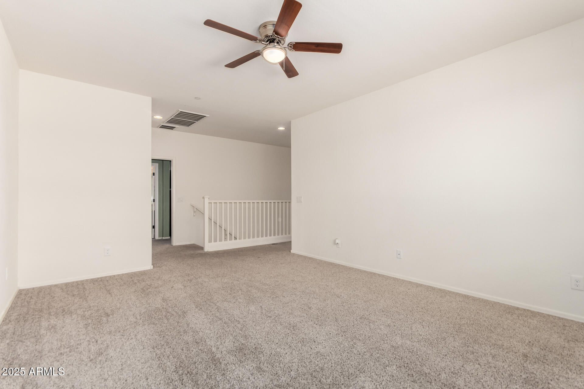 21243 West Coronado Road Buckeye, AZ 85396 - Photo 18 of 49 an empty room with a ceiling fan and a window