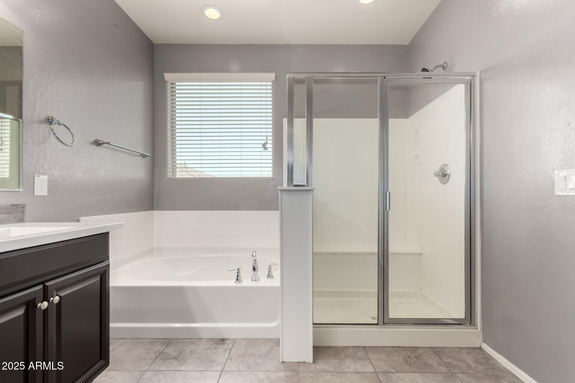 21243 West Coronado Road Buckeye, AZ 85396 - Photo 22 of 49 a bathroom with a bathtub and a sink