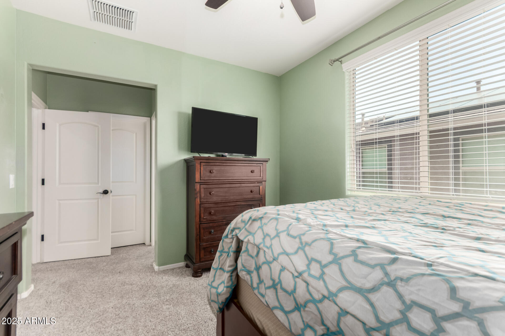 21243 West Coronado Road Buckeye, AZ 85396 - Photo 23 of 49 a bedroom with a bed and a flat screen tv