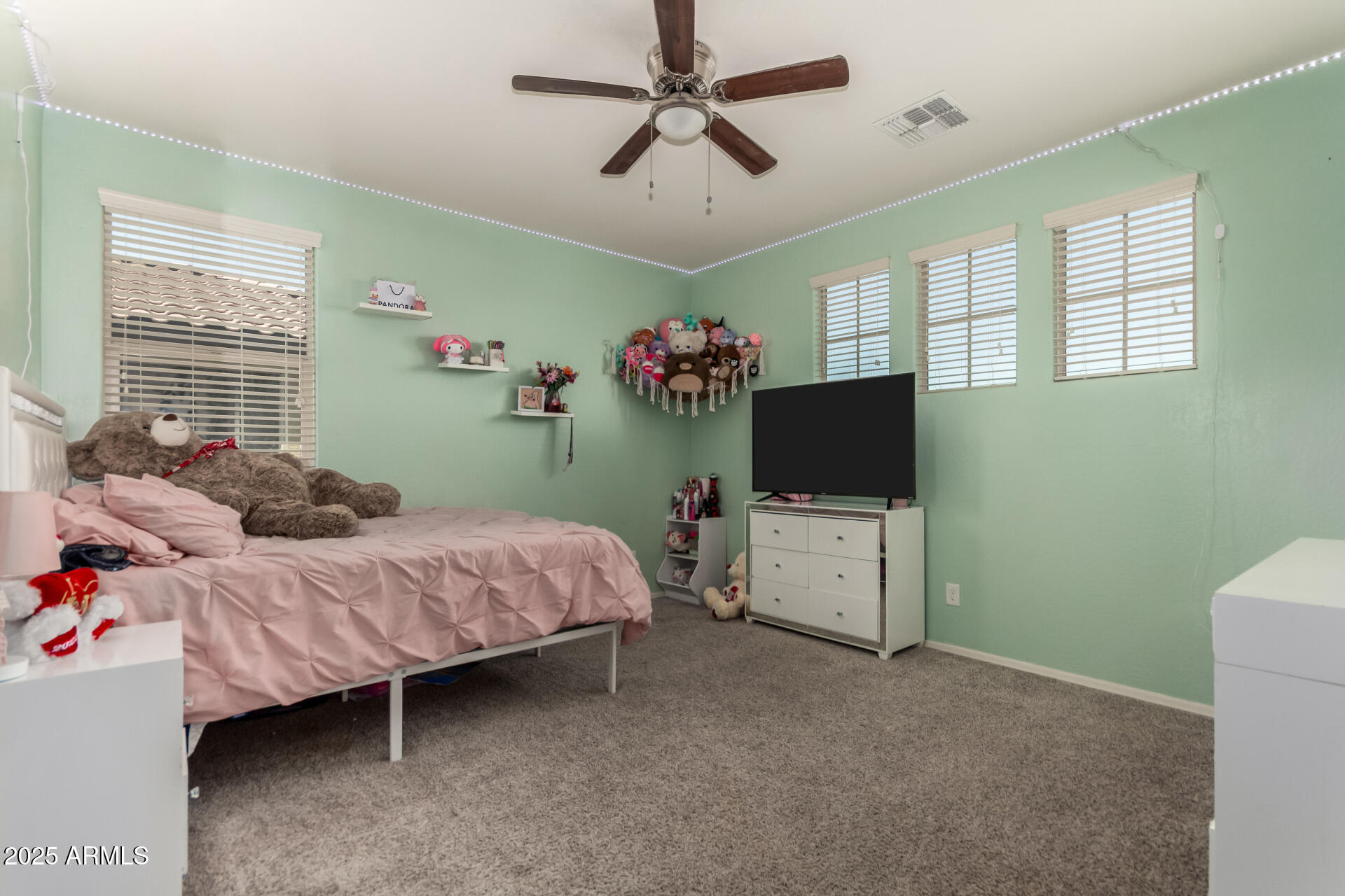 21243 West Coronado Road Buckeye, AZ 85396 - Photo 26 of 49 a bedroom with a bed and a flat screen tv