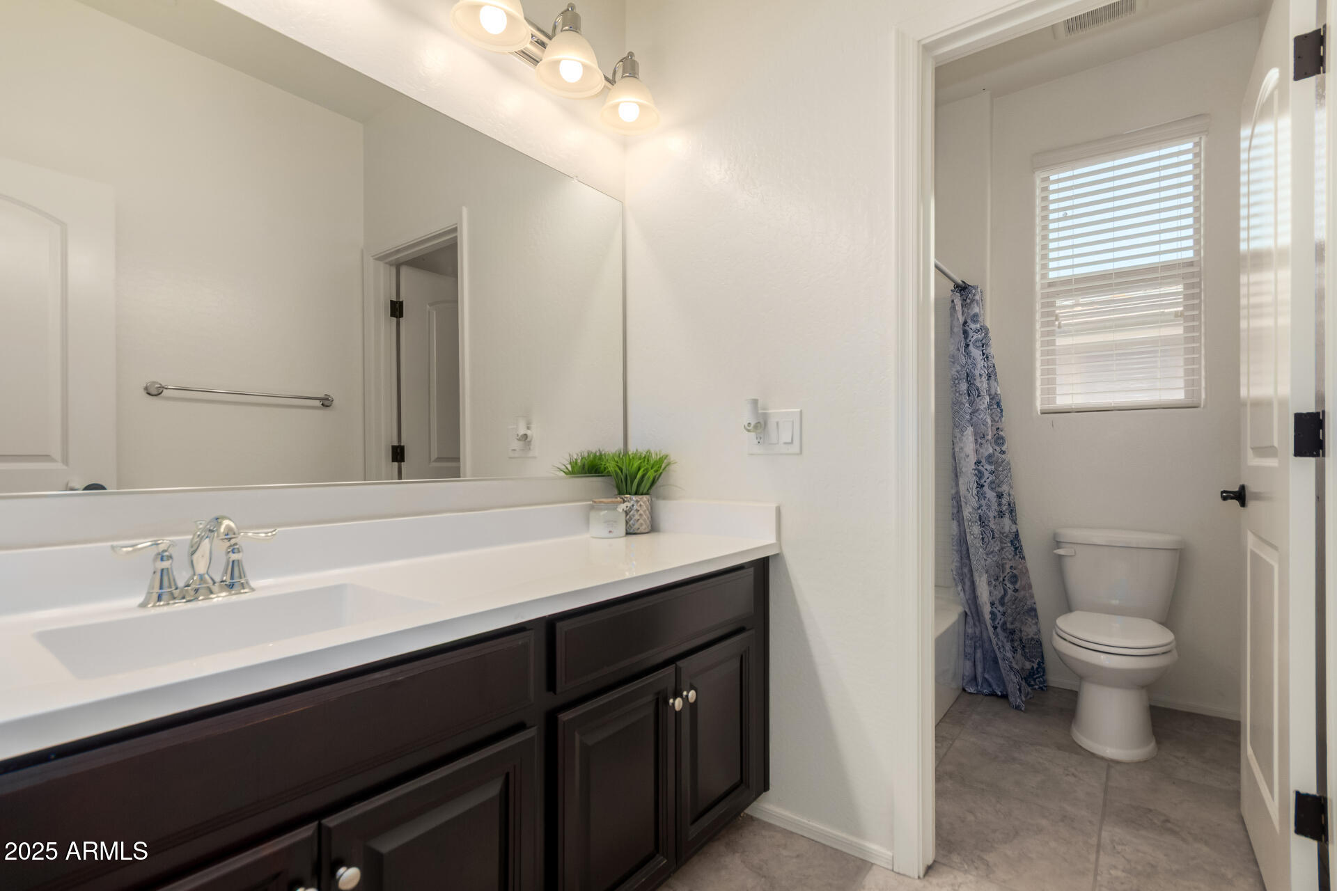 21243 West Coronado Road Buckeye, AZ 85396 - Photo 28 of 49 a bathroom with a double vanity sink toilet and a mirror