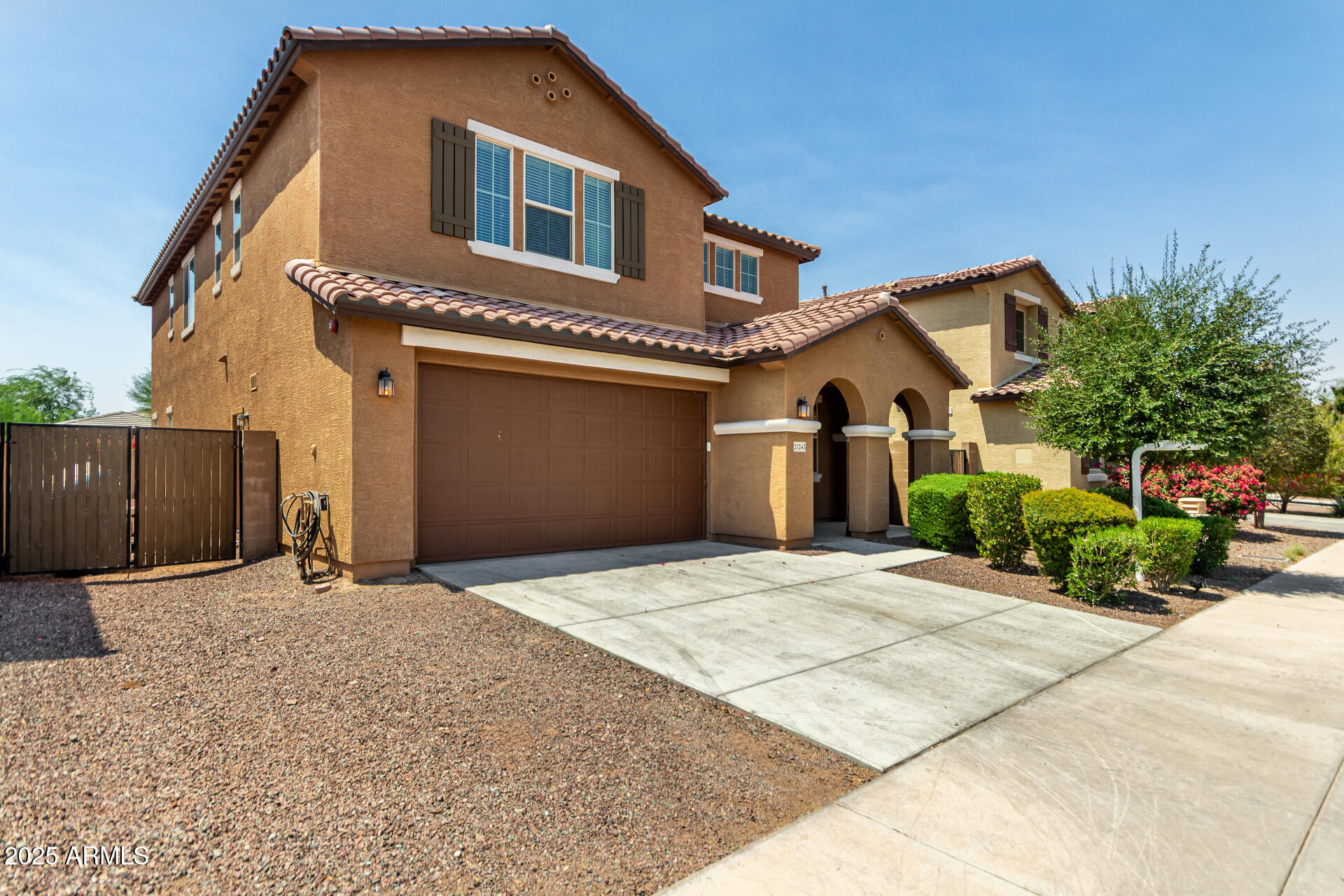 21243 West Coronado Road Buckeye, AZ 85396 - Photo 3 of 49 a front view of a house with a yard and garage