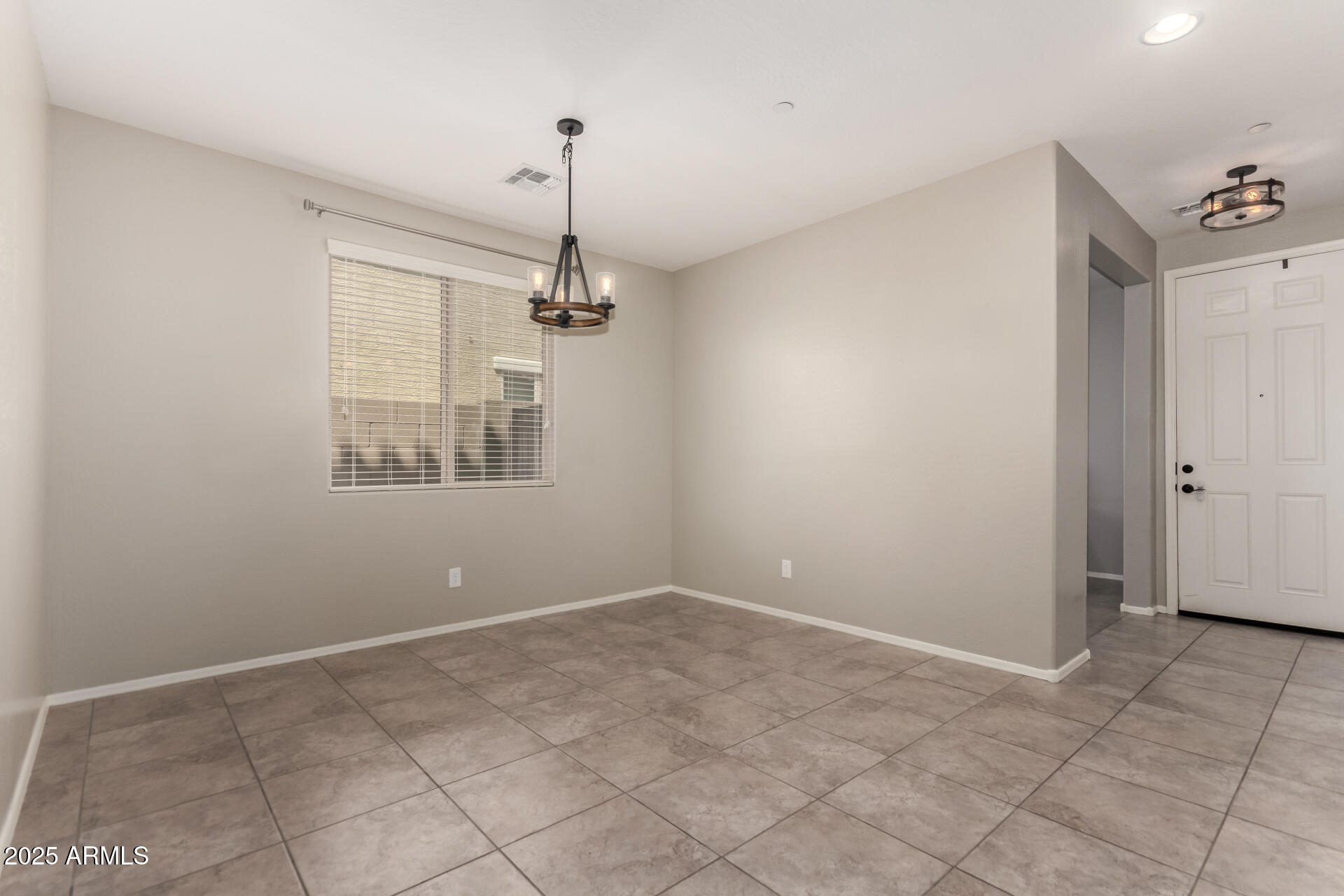 21243 West Coronado Road Buckeye, AZ 85396 - Photo 5 of 49 a view of an empty room with a window