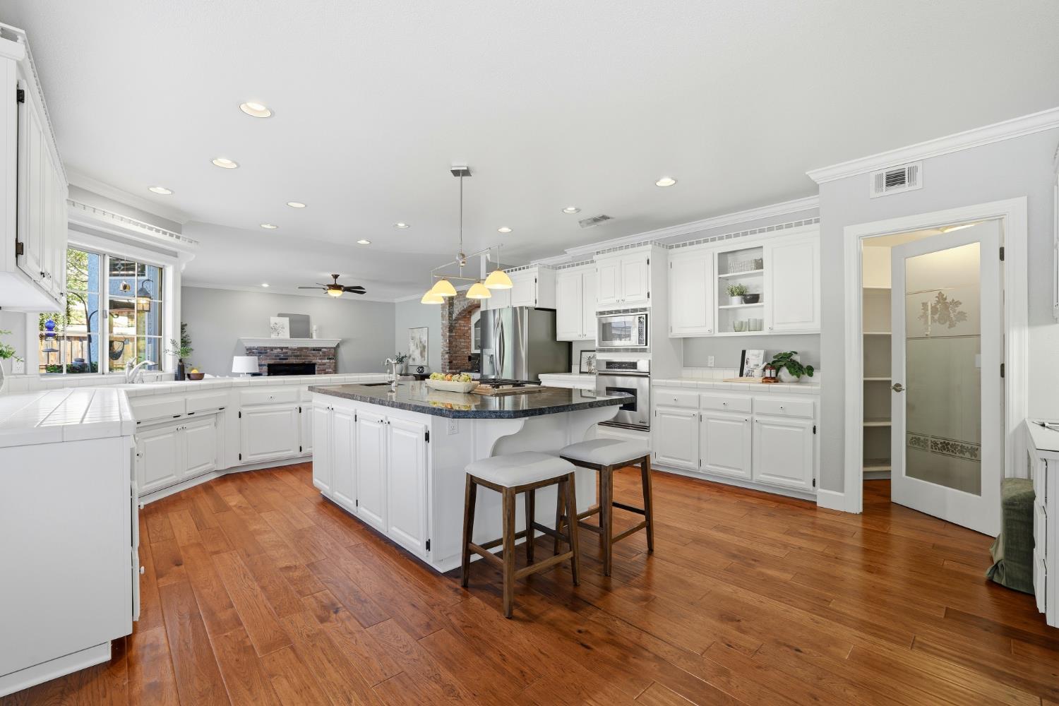 4330 Hale Ranch Lane Fair Oaks, CA 95628 - Photo 19 of 77 a kitchen with a sink cabinets and wooden floor