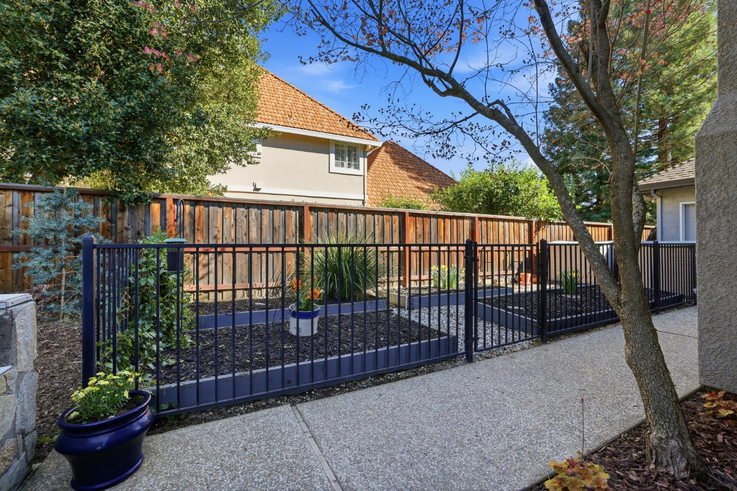 4330 Hale Ranch Lane Fair Oaks, CA 95628 - Photo 72 of 77 a view of a porch with a potted plant and floor to ceiling window and wooden fence