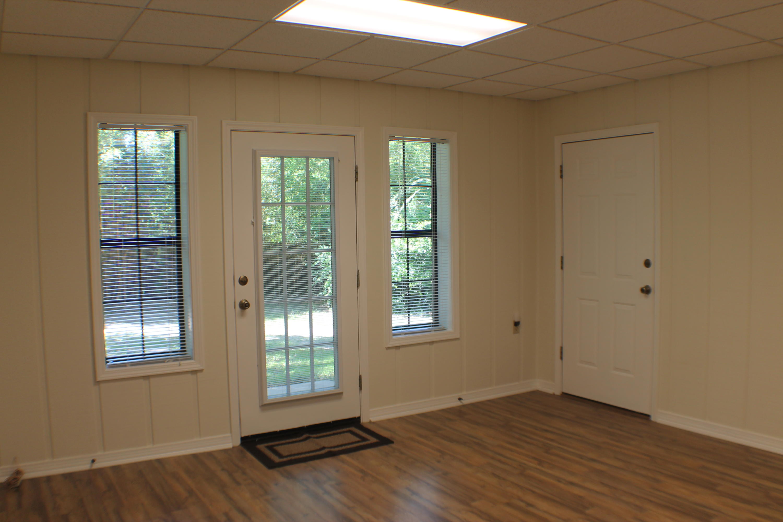 6564 Old River Road Baker, FL 32531 - Photo 24 of 70 a view of an empty room with wooden floor and a window