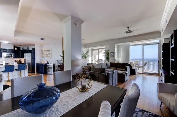 a living room with lots of furniture and wooden floor