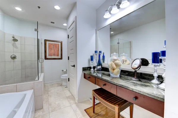 a living room with granite countertop furniture a rug and a view of bathroom