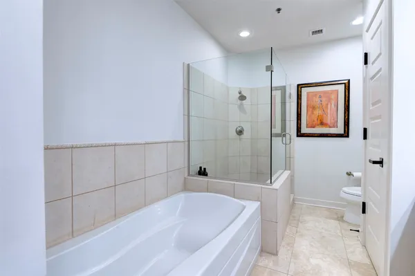 a bathroom with a bathtub and toilet