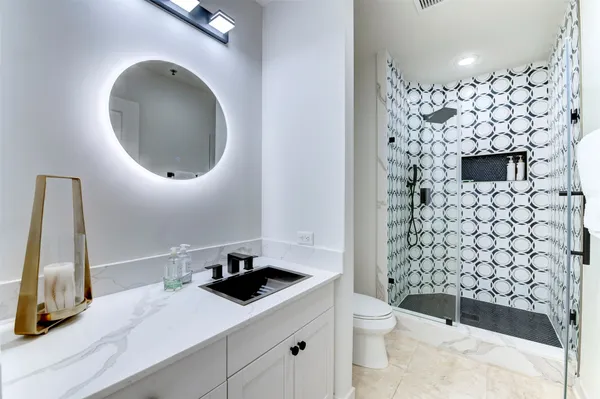 a bathroom with a sink a toilet and a mirror