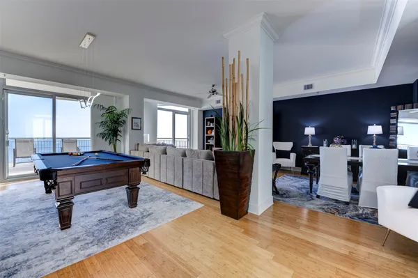 a living room with furniture a piano and a fireplace
