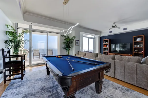 a room with furniture pool table and windows