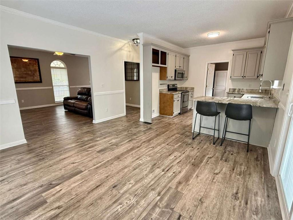 460 Rivers Road Fayetteville, GA 30214 - Photo 12 of 69 a view of kitchen with refrigerator microwave and wooden floor