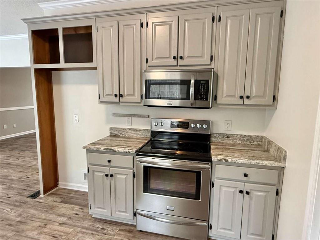 460 Rivers Road Fayetteville, GA 30214 - Photo 16 of 69 a kitchen with granite countertop white cabinets and stainless steel appliances