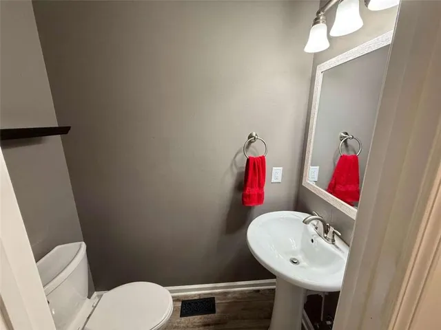 a bathroom with a double vanity sink toilet and shower