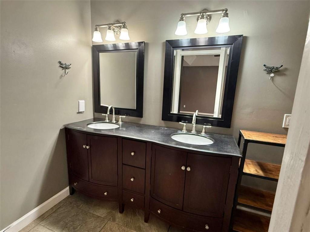 460 Rivers Road Fayetteville, GA 30214 - Photo 29 of 69 a bathroom with double vanity sinks and a mirror