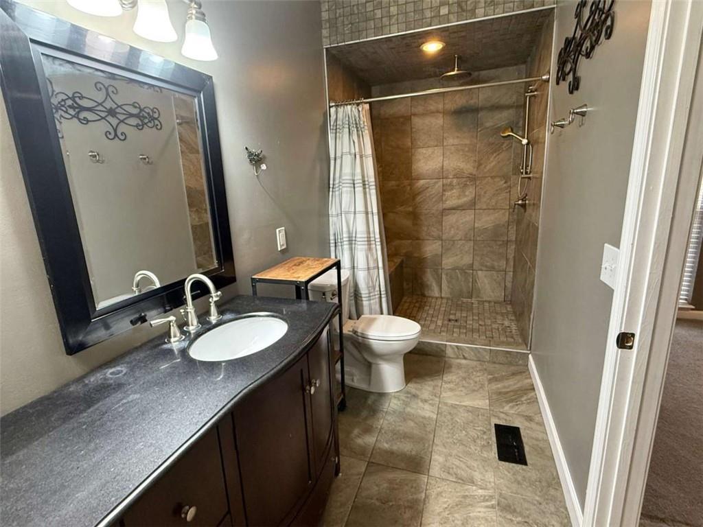 460 Rivers Road Fayetteville, GA 30214 - Photo 30 of 69 a bathroom with a double vanity sink toilet and shower