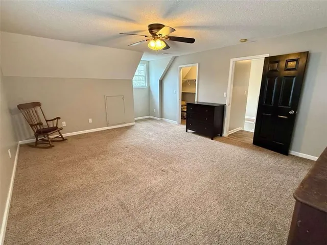 an empty room with wooden floor and closet