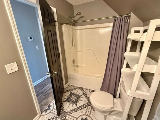 a view of a room with wooden floor and a window