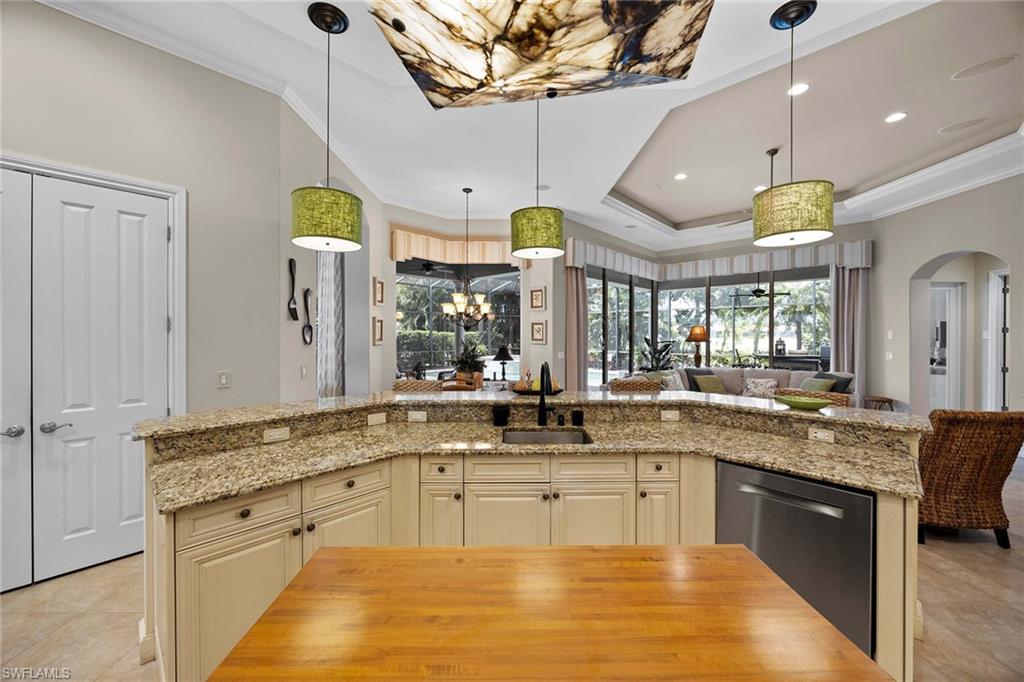 9038 Shenendoah Circle Naples, FL 34113 - Photo 13 of 50 a large kitchen with a sink and chandelier