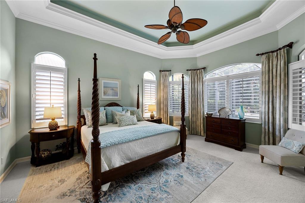 9038 Shenendoah Circle Naples, FL 34113 - Photo 14 of 50 a bedroom with a bed couches and a large window