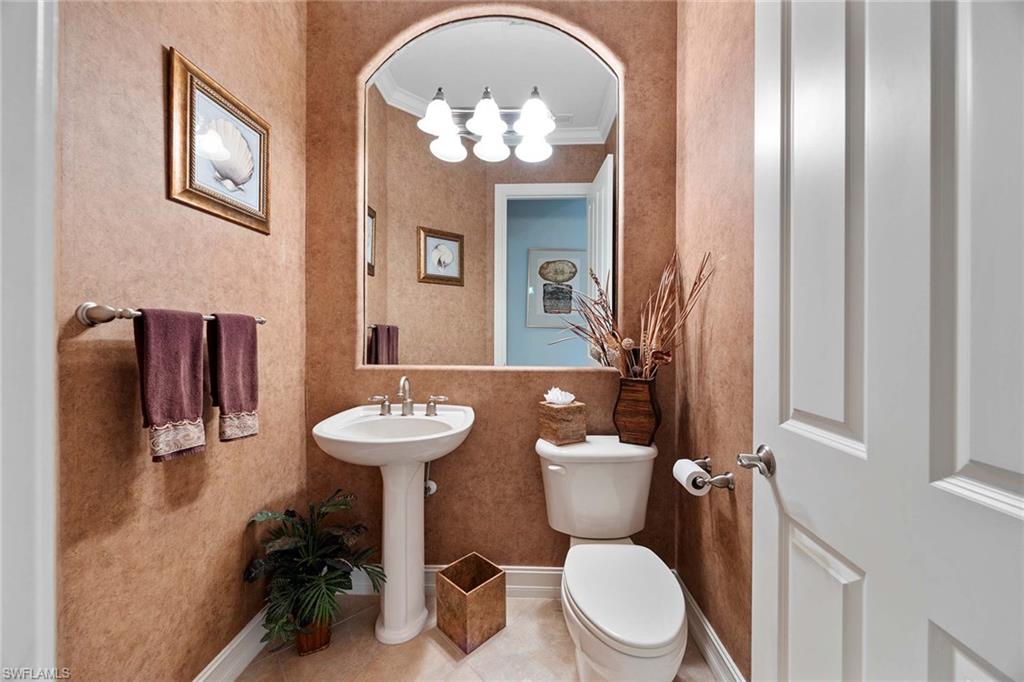 9038 Shenendoah Circle Naples, FL 34113 - Photo 19 of 50 a bathroom with a toilet a sink and mirror