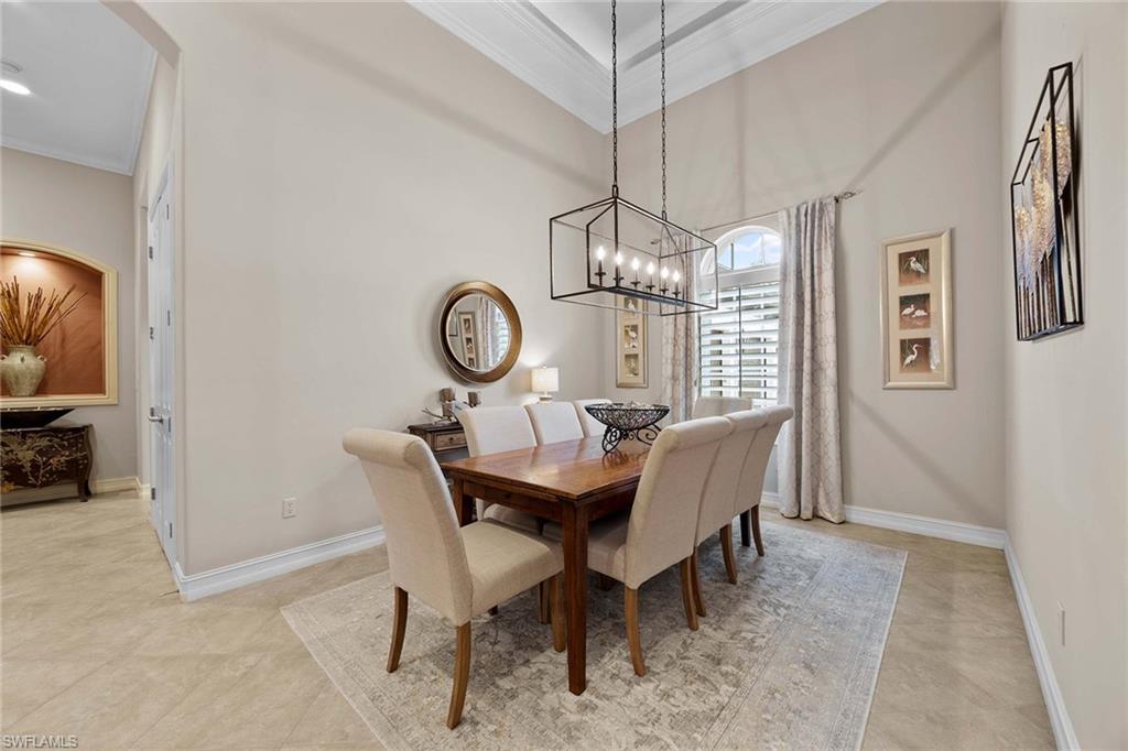 9038 Shenendoah Circle Naples, FL 34113 - Photo 20 of 50 a view of a dining room with furniture a chandelier and wooden floor