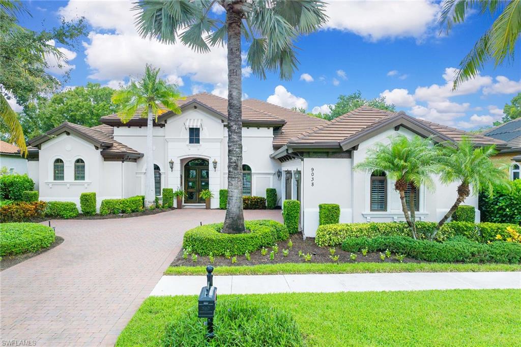 9038 Shenendoah Circle Naples, FL 34113 - Photo 2 of 50 a front view of a house with a yard and potted plants