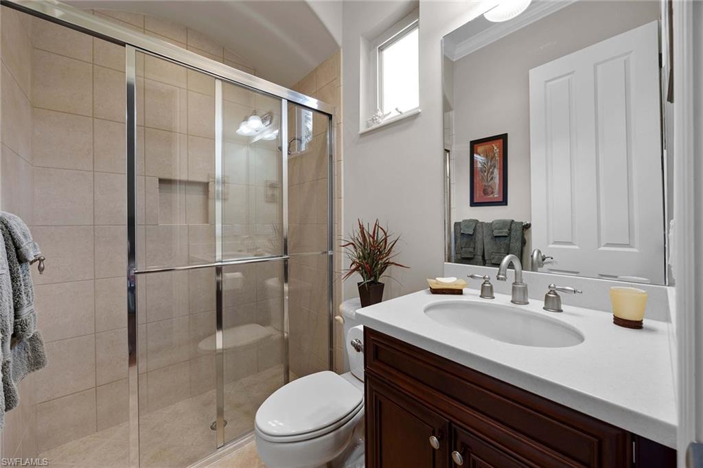 9038 Shenendoah Circle Naples, FL 34113 - Photo 23 of 50 a bathroom with a sink toilet and shower