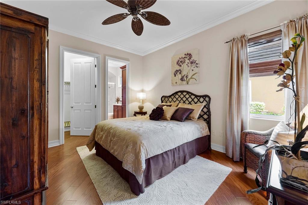 9038 Shenendoah Circle Naples, FL 34113 - Photo 24 of 50 a bedroom with a bed and a chandelier