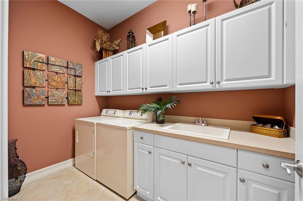 9038 Shenendoah Circle Naples, FL 34113 - Photo 31 of 50 a utility room with stainless steel appliances white cabinets and a sink