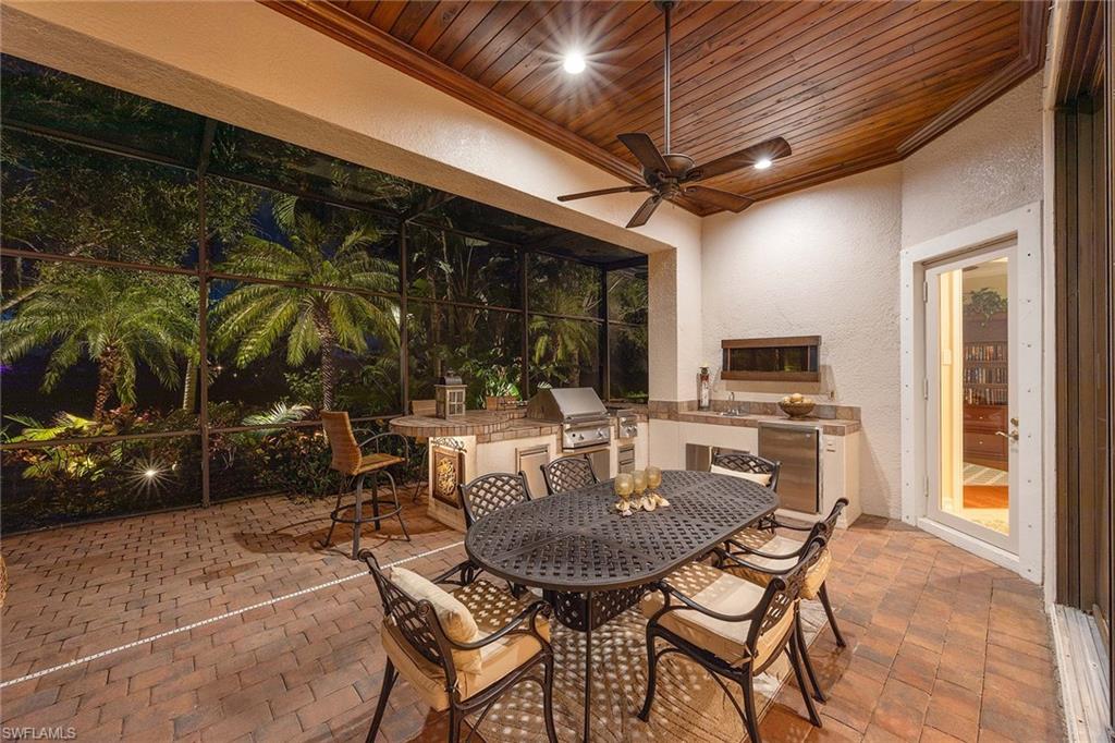9038 Shenendoah Circle Naples, FL 34113 - Photo 39 of 50 a table and chairs in front of a glass door